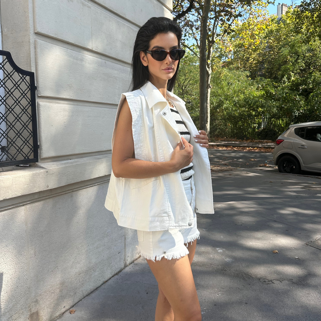 Veste blanche sans manche tendance, short blanc à franges 